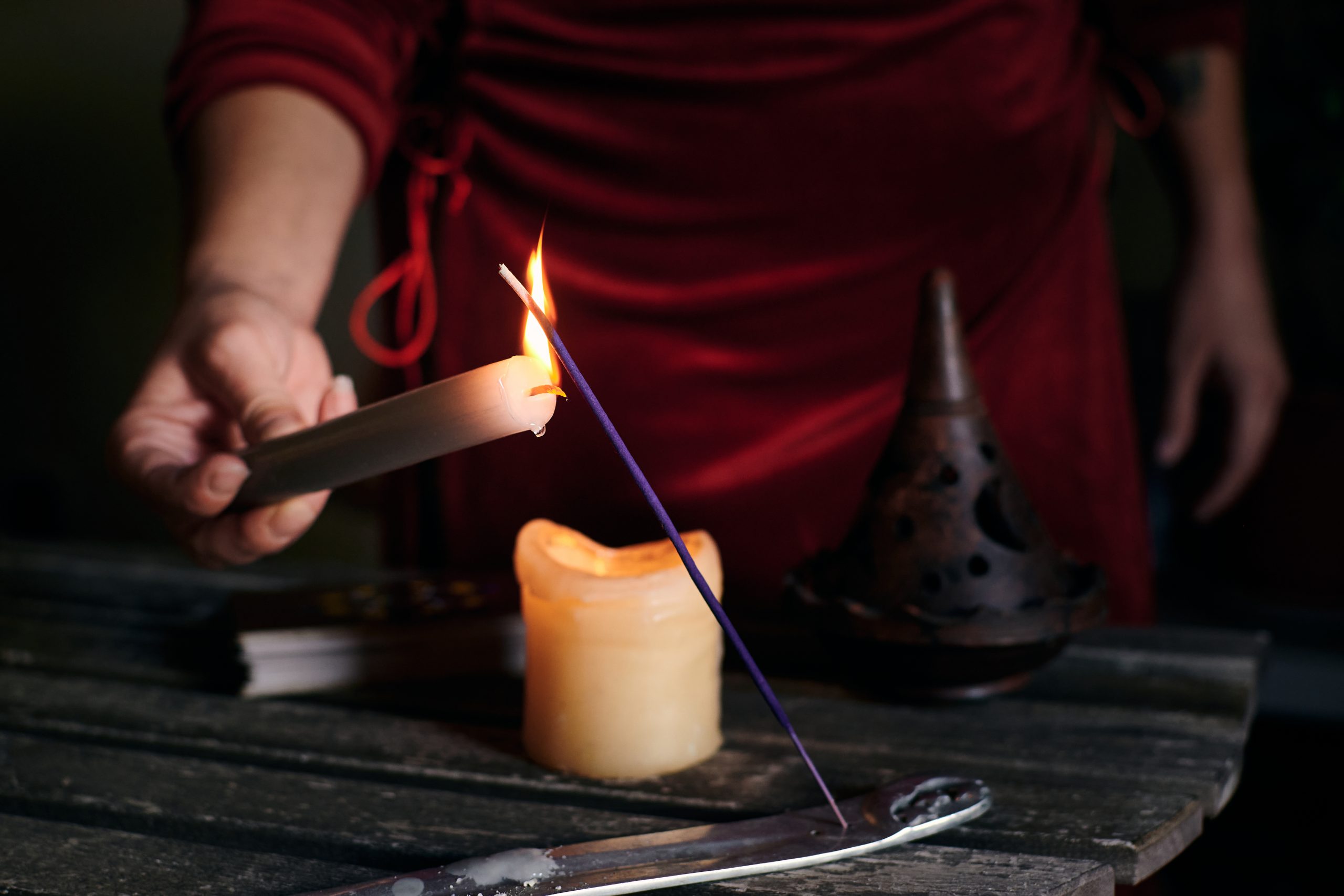 Close-up of a woman's hand lighting incense